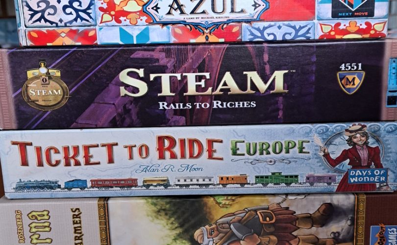 Picture shows a stack of board games
